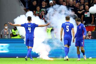 England’s Declan Rice gestures towards the fans as a flare is thrown onto the pitch in Budapest