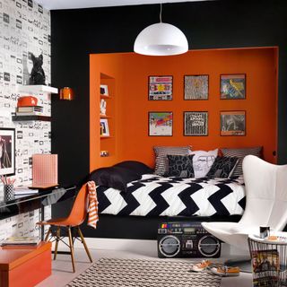 room with orange wall and black frame