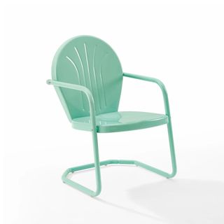 A retro metal outdoor chair in a mint green color