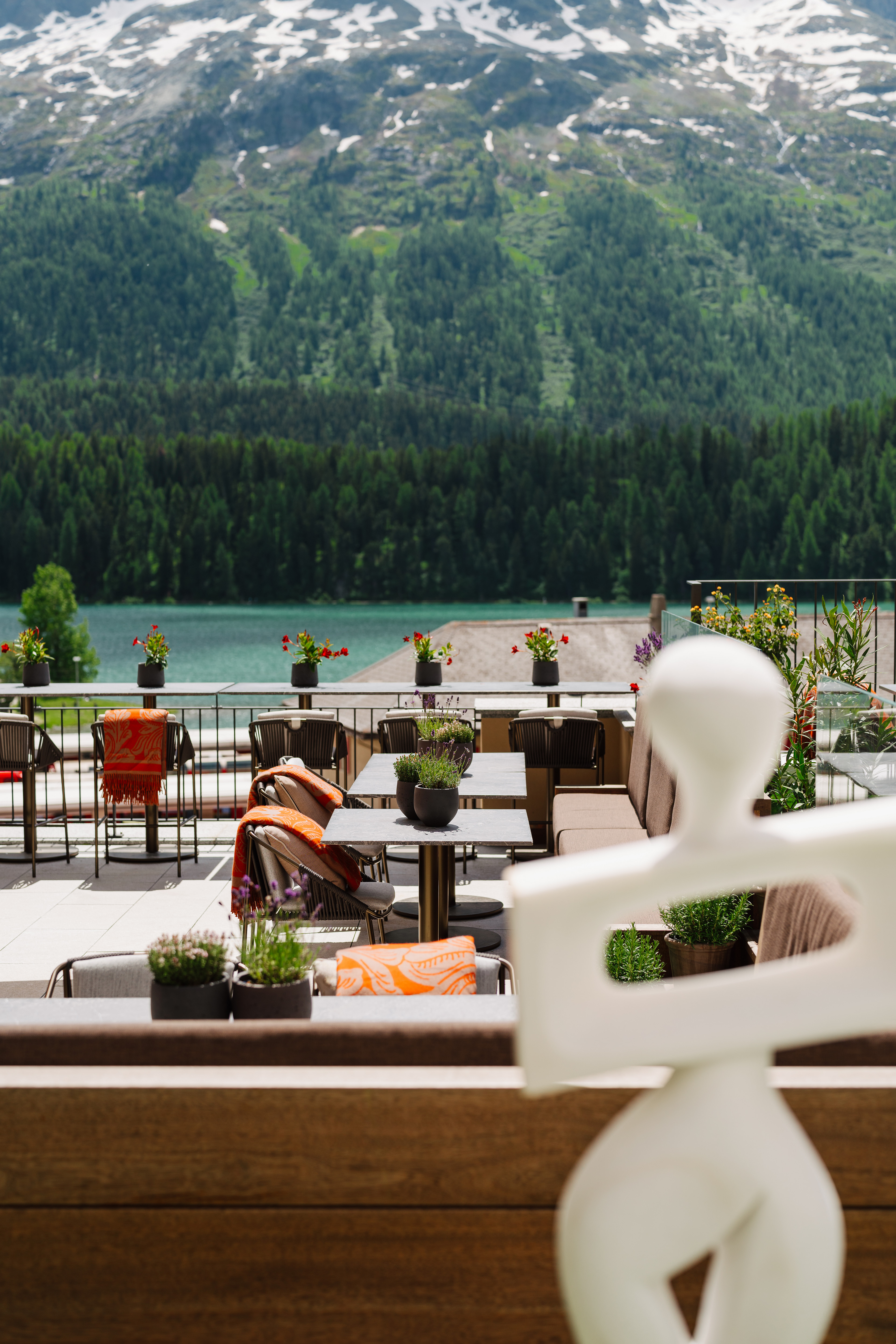 A hotel's scenic setting boasts sun-lit, airy views of the surrounding mountainous nature.