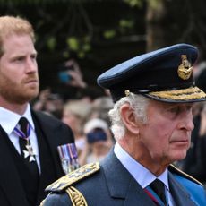 Britain's King Charles III and Britain's Prince Harry, Duke of Sussex walk behind the coffin of Queen Elizabeth II.