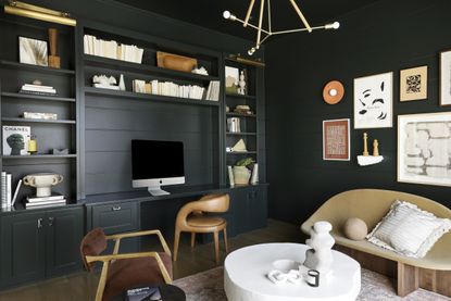 A black office with a sofa in tan 