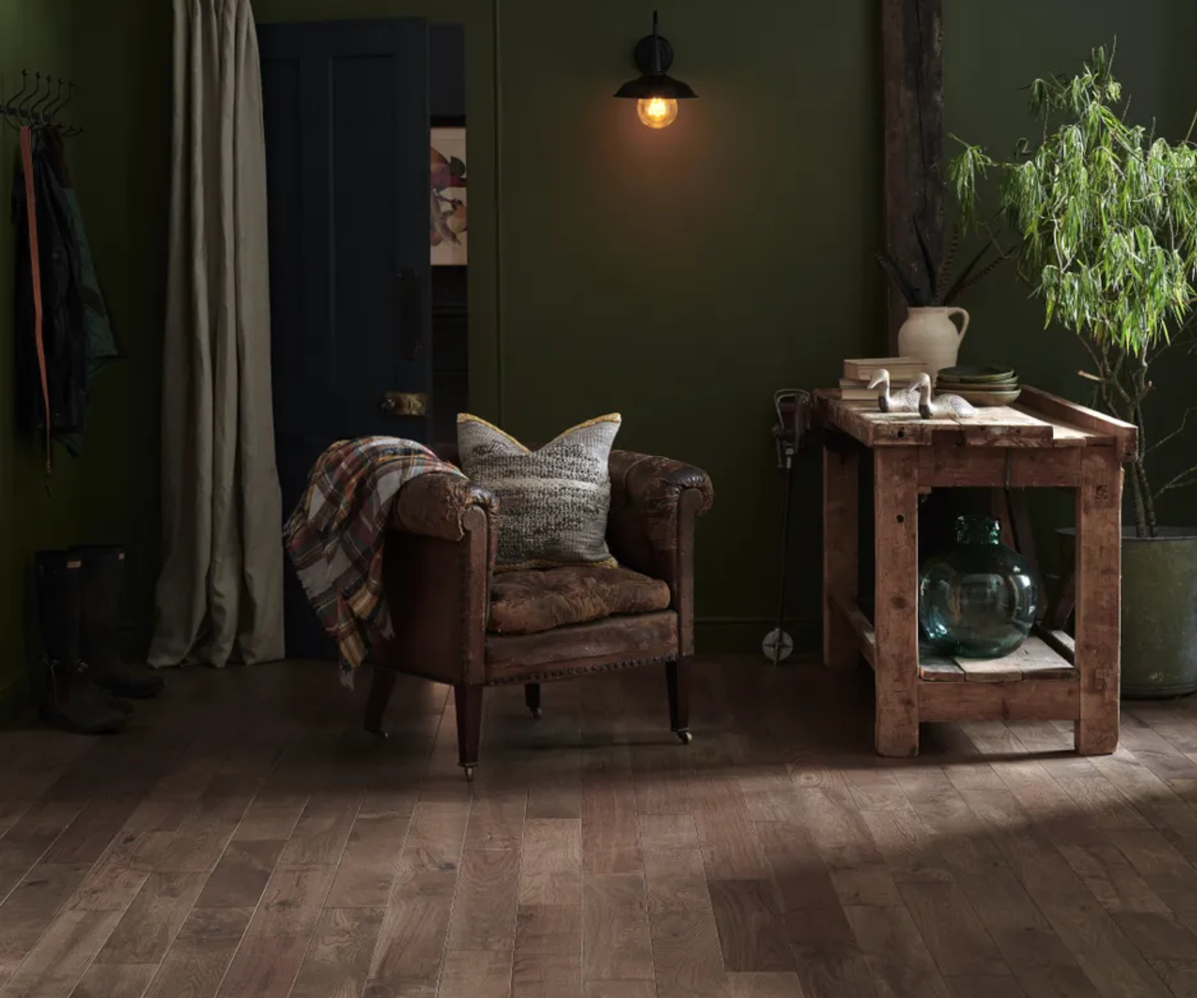dark herringbone solid wood flooring with dark green walls