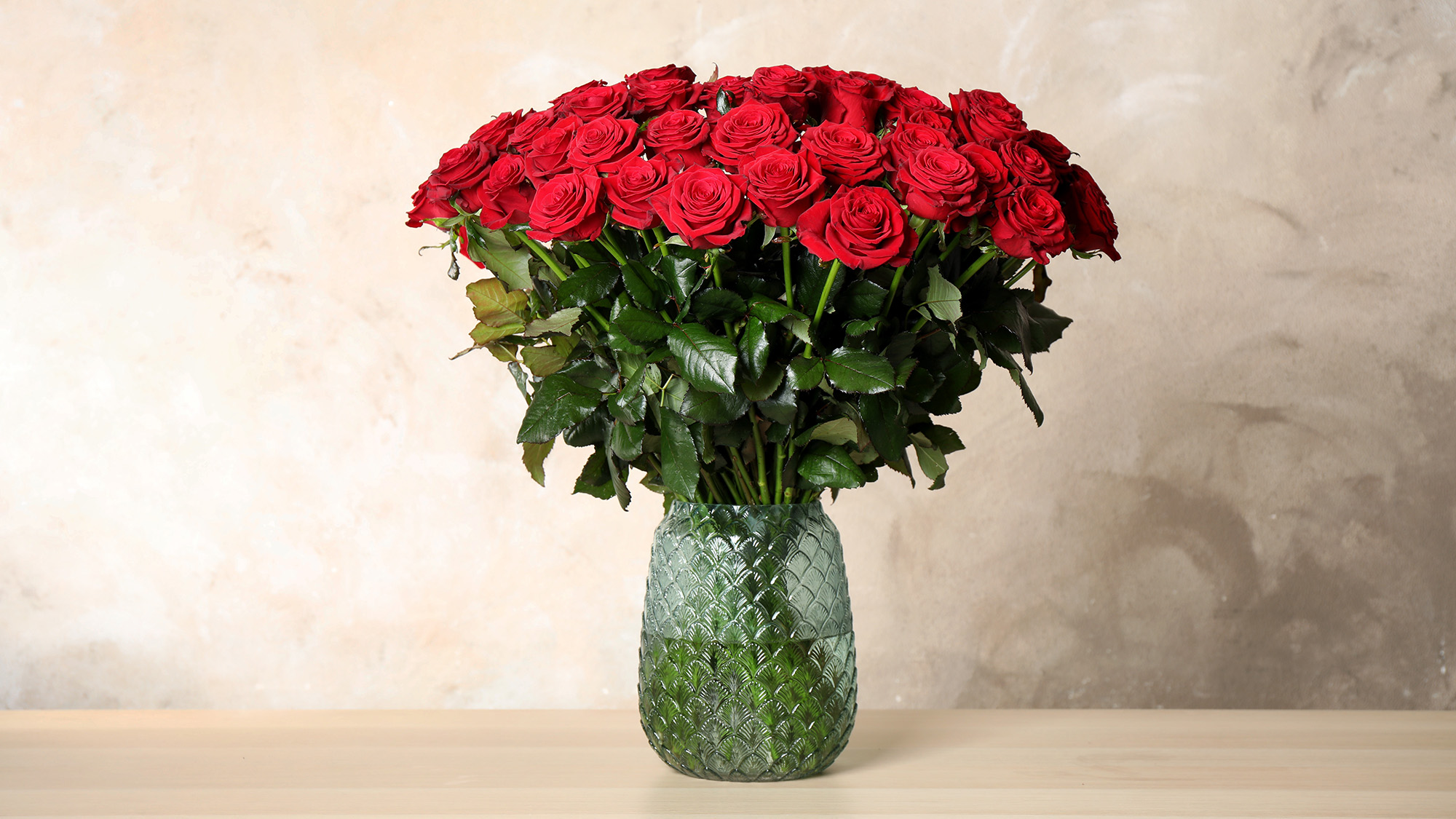 Glass vase of red roses
