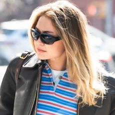 Gigi Hadid wore the rugby shirt trend with a leather bomber jacket and straight-leg jeans