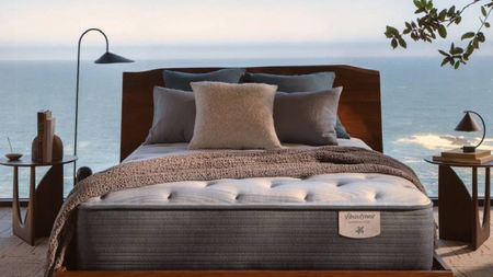 A mattress and bed frame from Beautyrest in front of a relaxing, sea view.