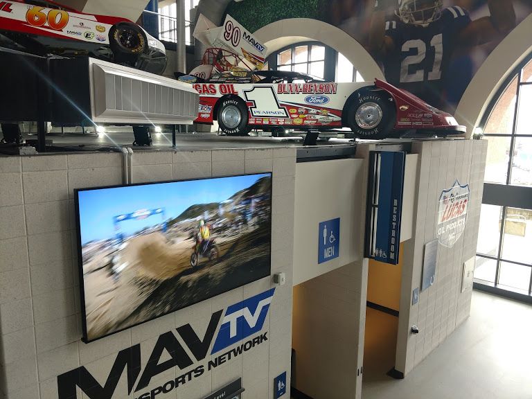 Screens throughout the venue are incorporated into themed exhibits highlighting the history of racing, and Lucas Oil’s involvement in the automotive industry.