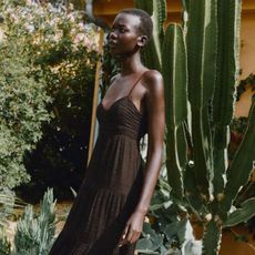 Woman wears brown dress