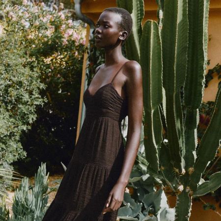 Woman wears brown dress