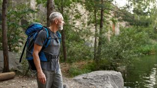 a photo of a man hiking alone 