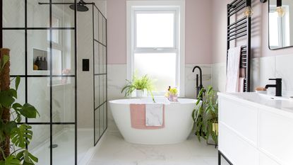 Small white bathroom with herringbone layout of white metro tiles on wall and bath side