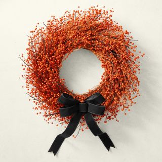 Orange berry wreath with black ribbon