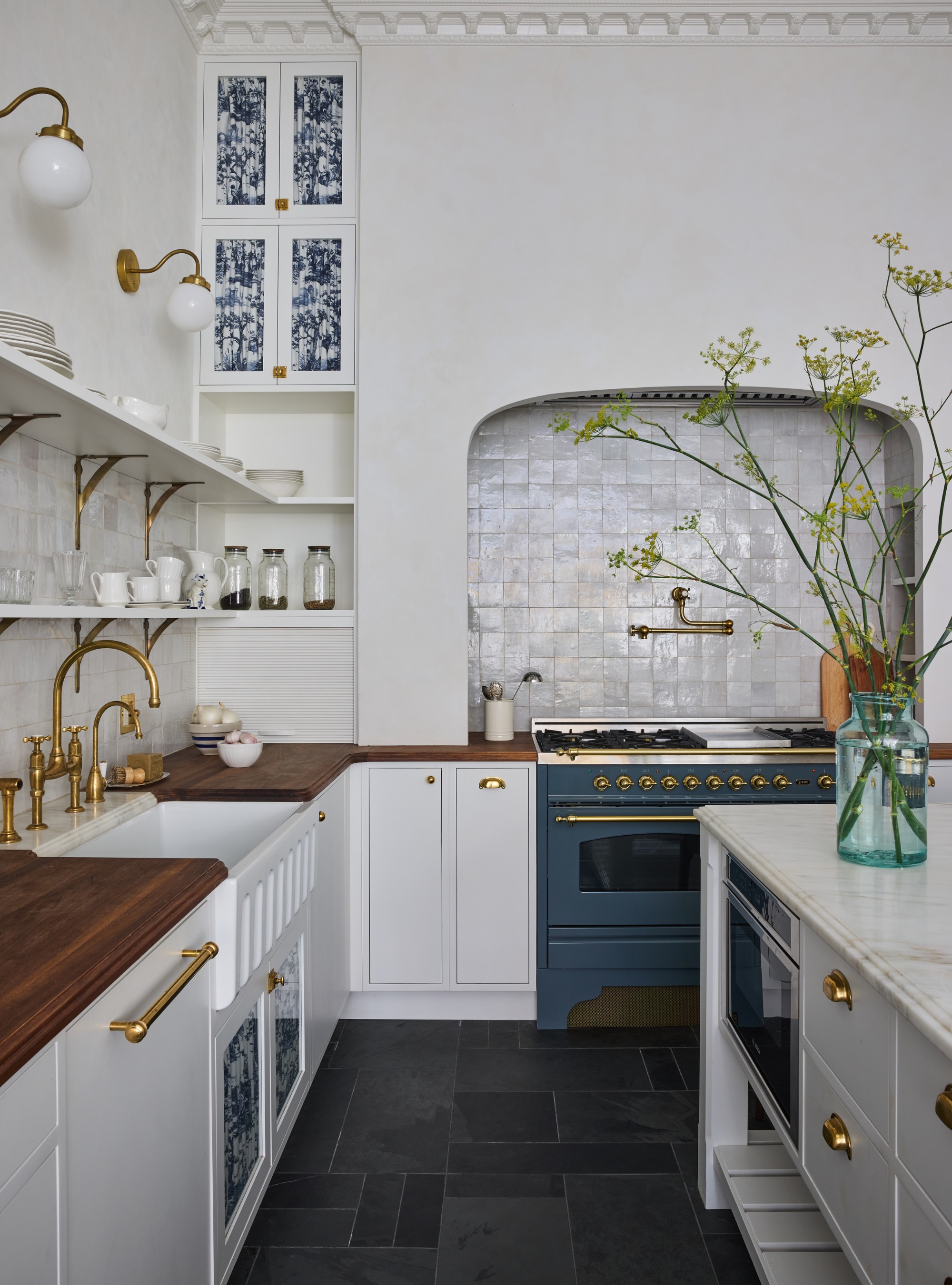 White kitchen with wood countertops and a tiled backsplash