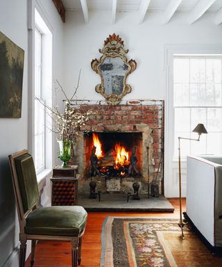 Stone fireplace, mirror, green vase and chair