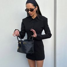 Woman in black blazer dress and bag