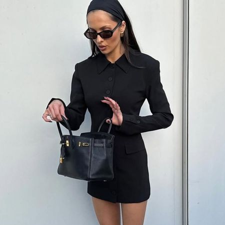 Woman in black blazer dress and bag