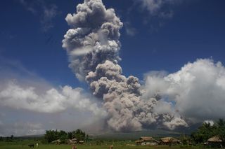 A giant mushroom-shaped cloud rises into the air from the Mayon volcano, seen from the highway in the town of Camalig, near Legazpi City in Albay province, south of Manila on Jan. 22, 2018.