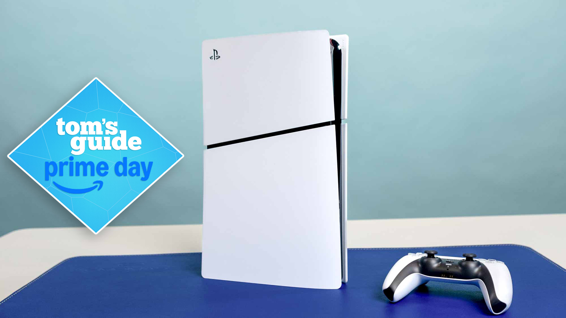A PS5 Slim console on desk with DualSense controller next to it and Prime Day deal badge overlaid