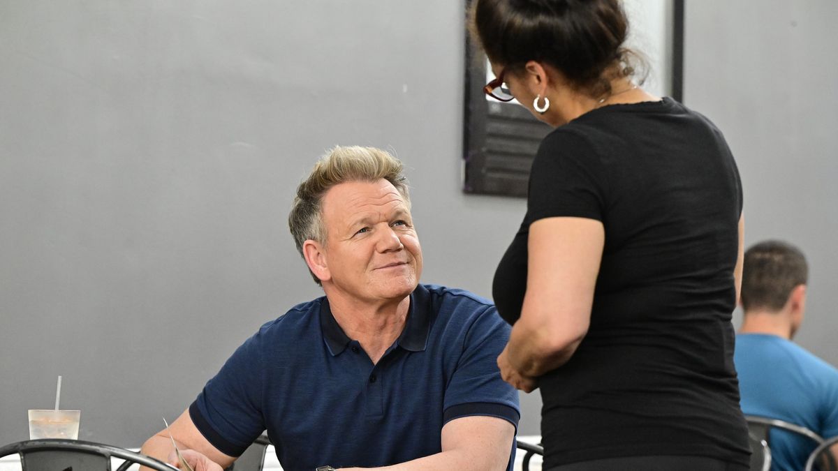 Gordon Ramsay sits at a table speaking to an employee at El Cantito on Kitchen Nightmares season 8