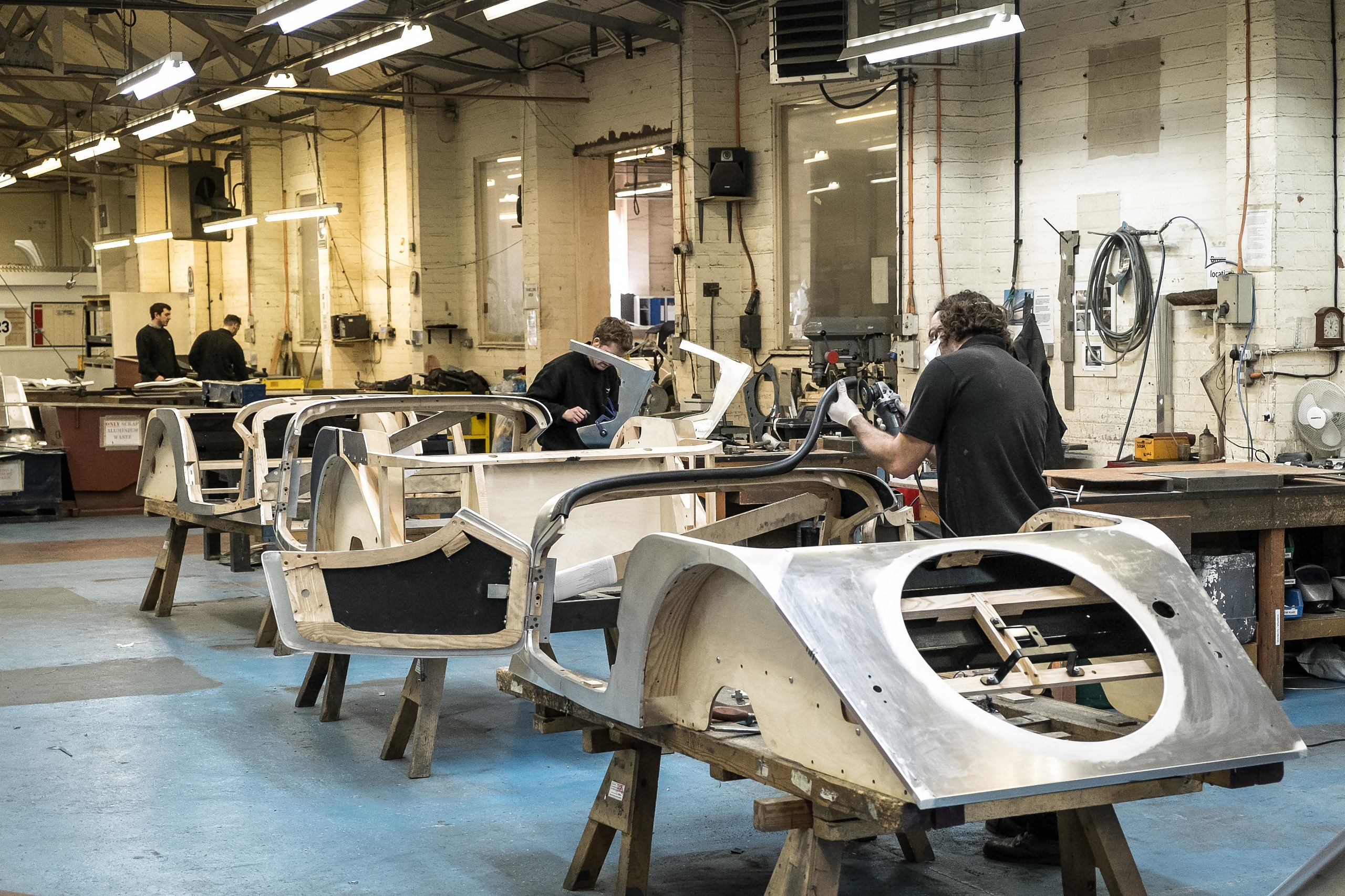 A view of the Morgan factory, showing workers building cars by hand
