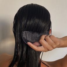 Woman combing wet hair