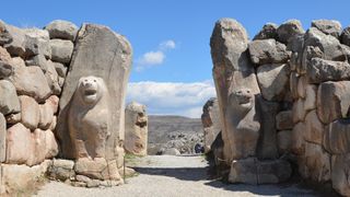 A large stone entry way with animal statues.