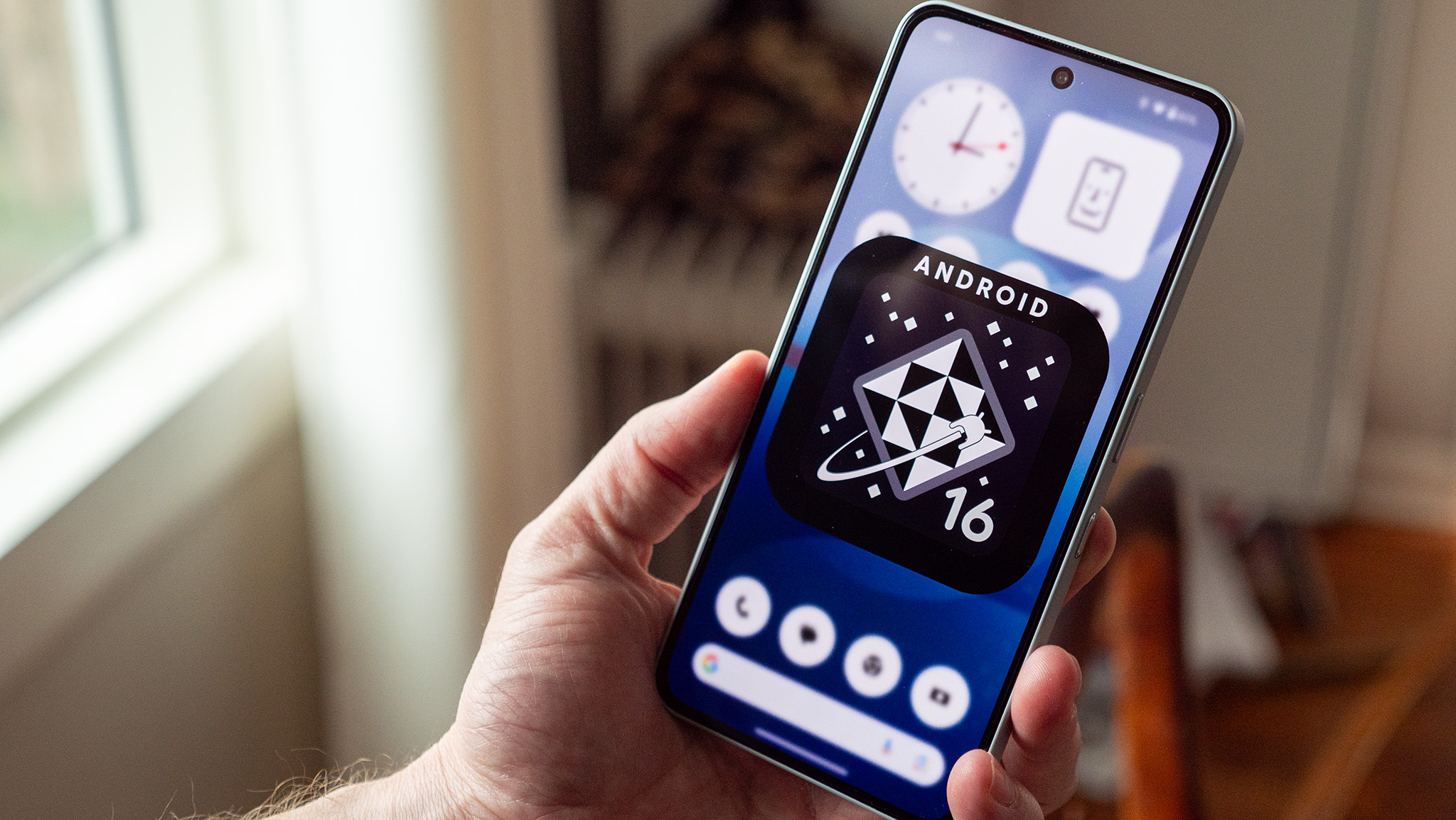 A black and white Android 16 logo on a Nothing Phone 3a Pro