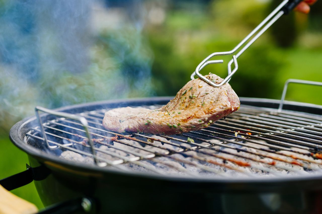 Grilling lamb fillet on charcoal grill