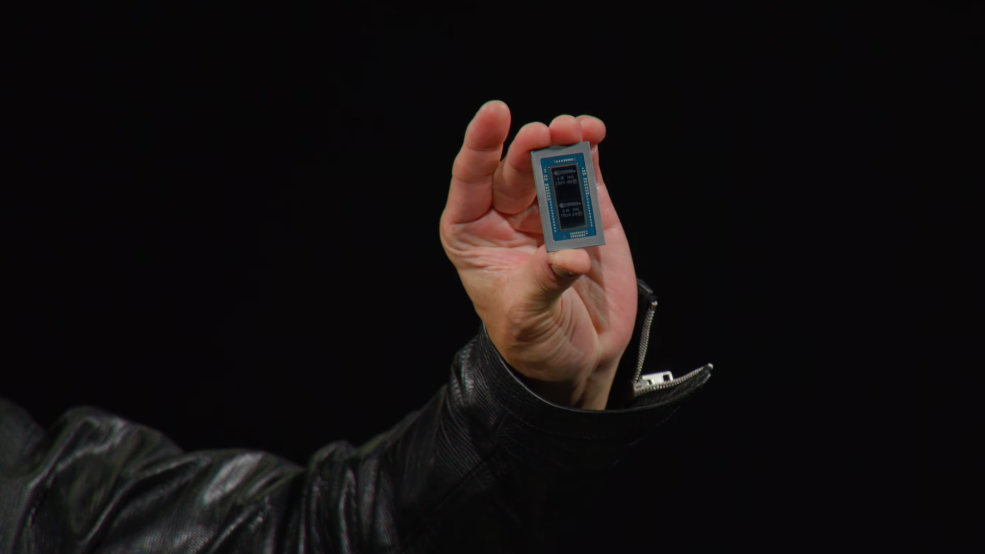 Hand holding Nvidia Spark superchip against a black background