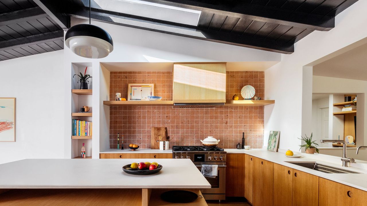 A contemporary kitchen with a blush pink square-tiled backsplash