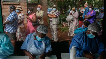 Patients queue for a vaccination in Harare, Zimbabwe 