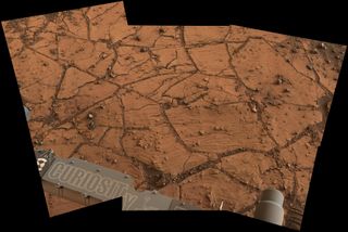 A patch of Martian bedrock, about 2 feet (70 centimeters) across appears to consist of finely layered rock with some pea-size inclusions. NASA's Curiosity Mars rover acquired this view on Nov. 9, 2014.
