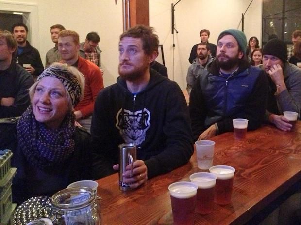 Cycling fans watch as Lance Armstrong admits doping to Oprah Winfrey.