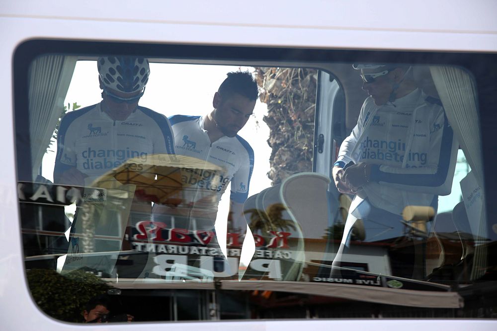 Riders getting ready for stage 2 inside their team bus.