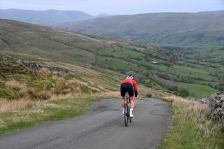 Cyclist Simon Warren descending a hill in North West England