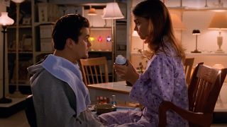 Katie Holmes as Joey holding up shaving cream to Joshua Jackson as Pacey in Dawson's Creek. Pacey has a towel around his neck.