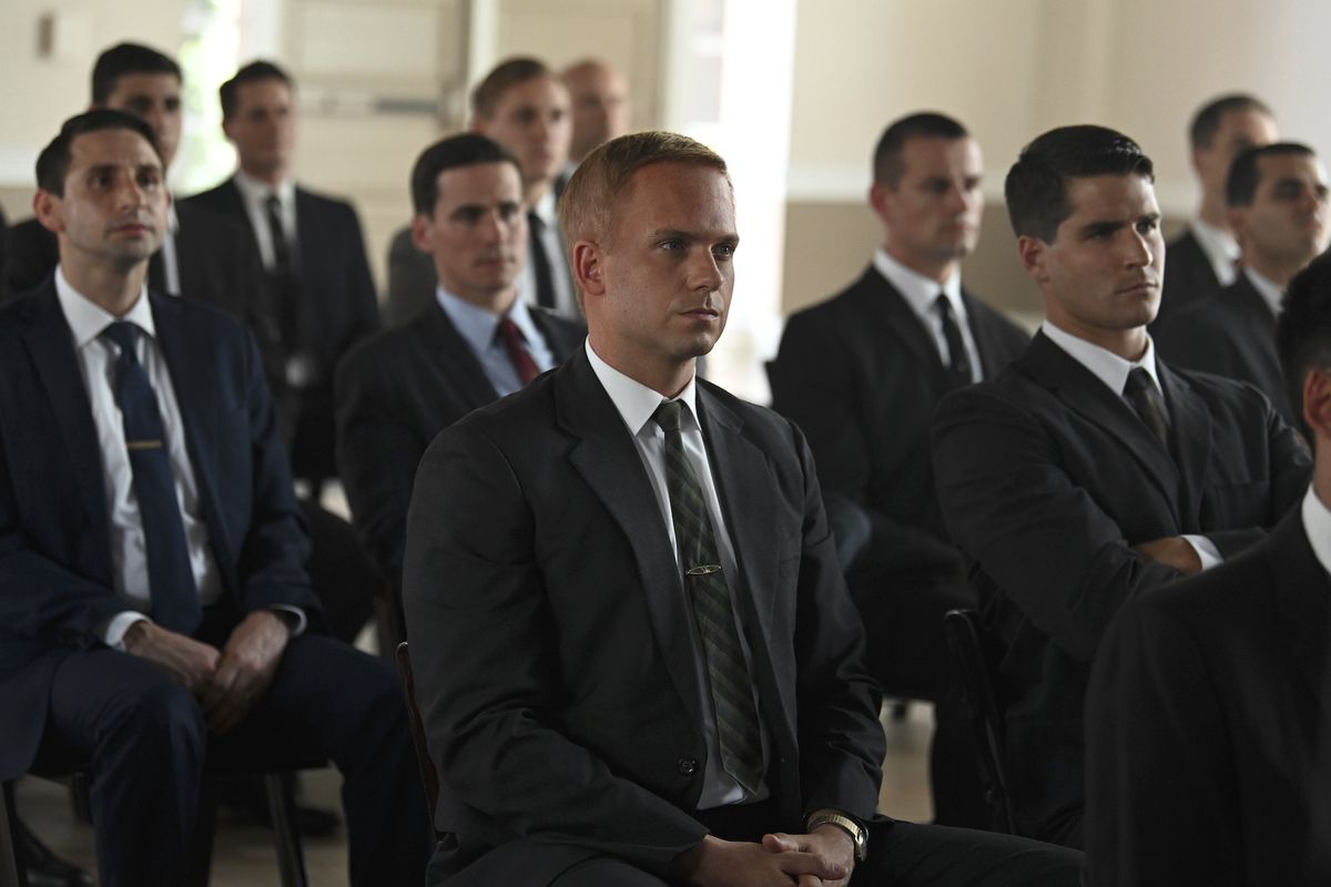 Patrick J. Adams (center) stars as Maj. John Glenn in The Right Stuff.