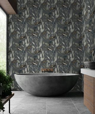 Grey printed wallpaper design with freestanding tub by Graham and Brown