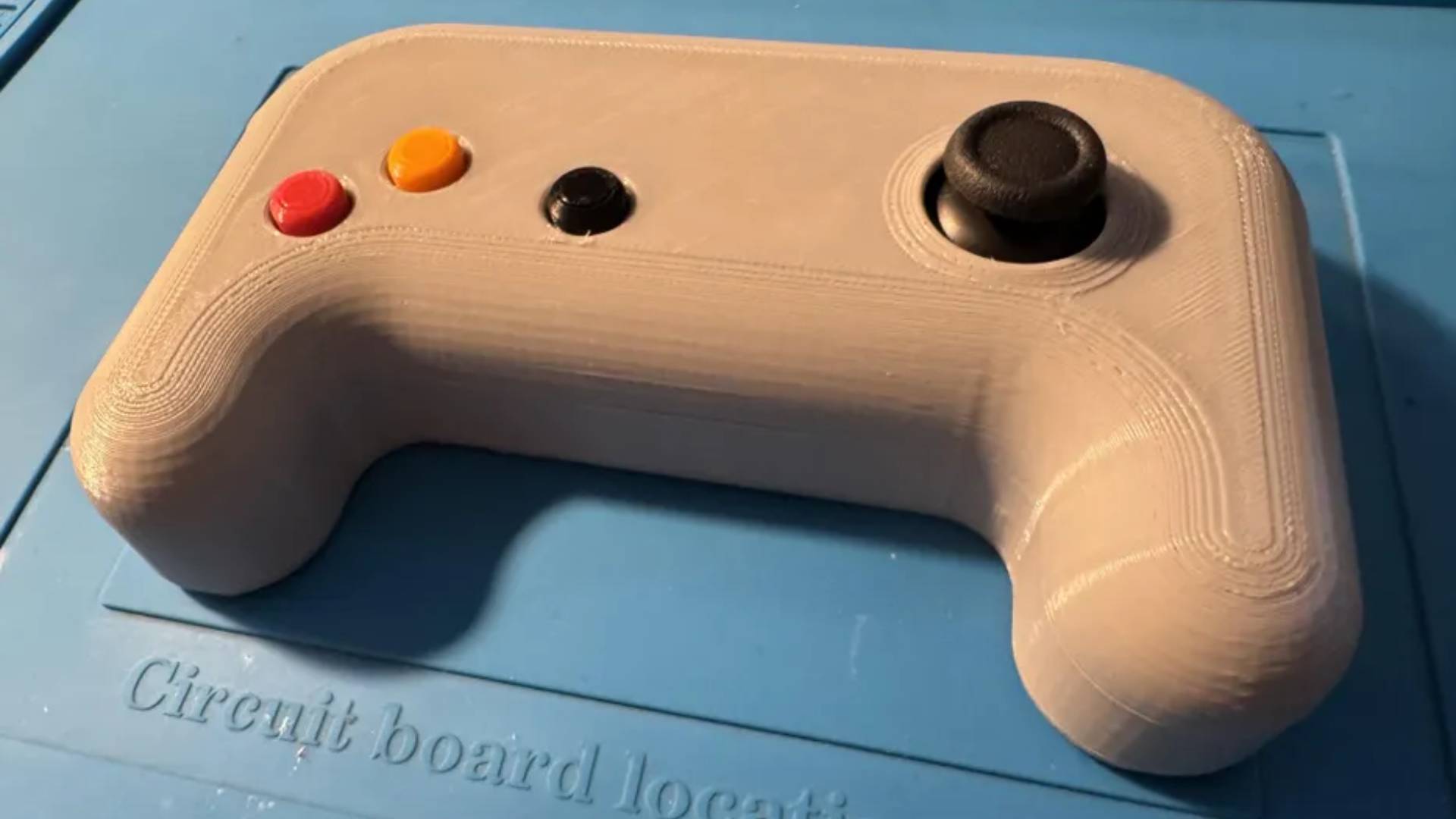 A very budget, 3D printed, DIY PC controller. I has one analogue stick on the right, and only three visible buttons on the left (These are the 'X', Y', and menu buttons).