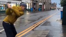 A player takes a shot from a St Andrews street