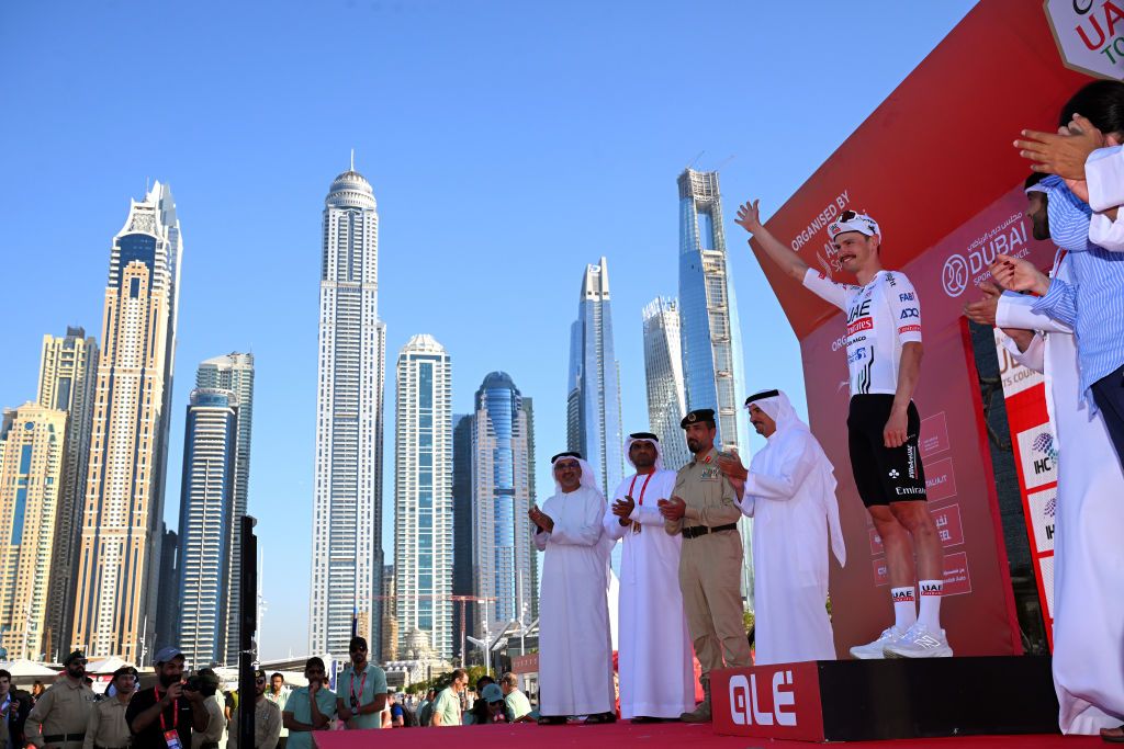 DUBAI HARBOUR DUBAI UNITED ARAB EMIRATES FEBRUARY 22 Jay Vine of Australia and Team UAE Emirates Red Leader Jersey celebrates at podium during the 6th UAE Tour 2024 Stage 4 a 168km stage from Dubai Police Officers Club to Dubai Harbour UCIWT on February 22 2024 in Dubai United Arab Emirates Photo by Tim de WaeleGetty Images