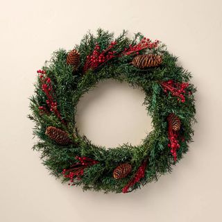 Evergreen & Winterberry Christmas Wreath against a cream background.