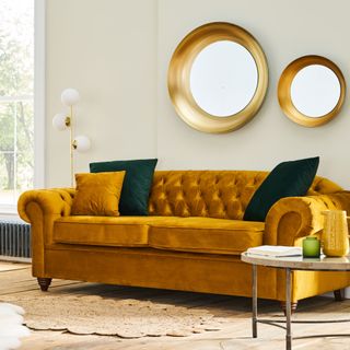 Velvet mustard sofa with accent cushions in living room
