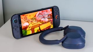 Nintendo Switch and Sony WH-1000XM5 headphones on a white surface