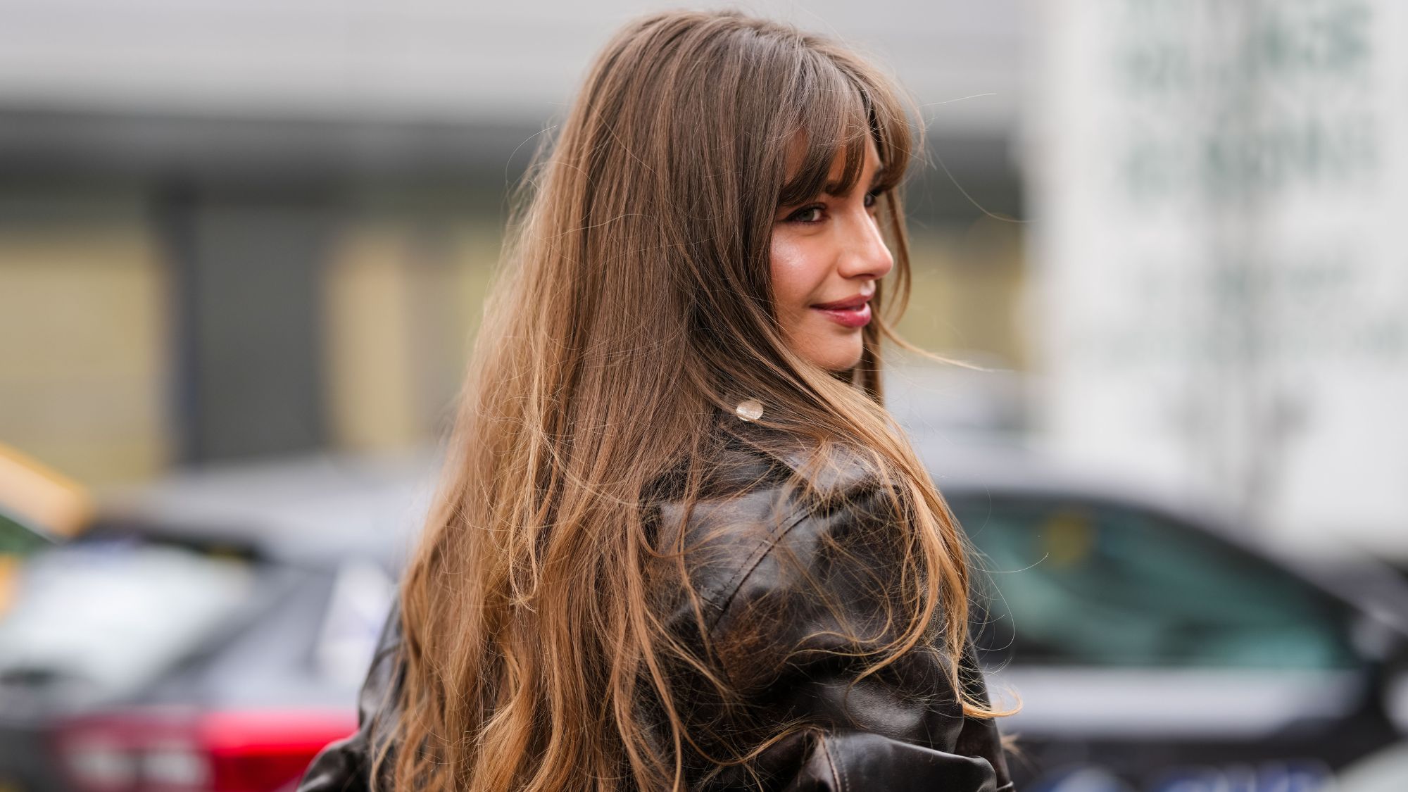 street style shot of woman with long brown hair and a fringe