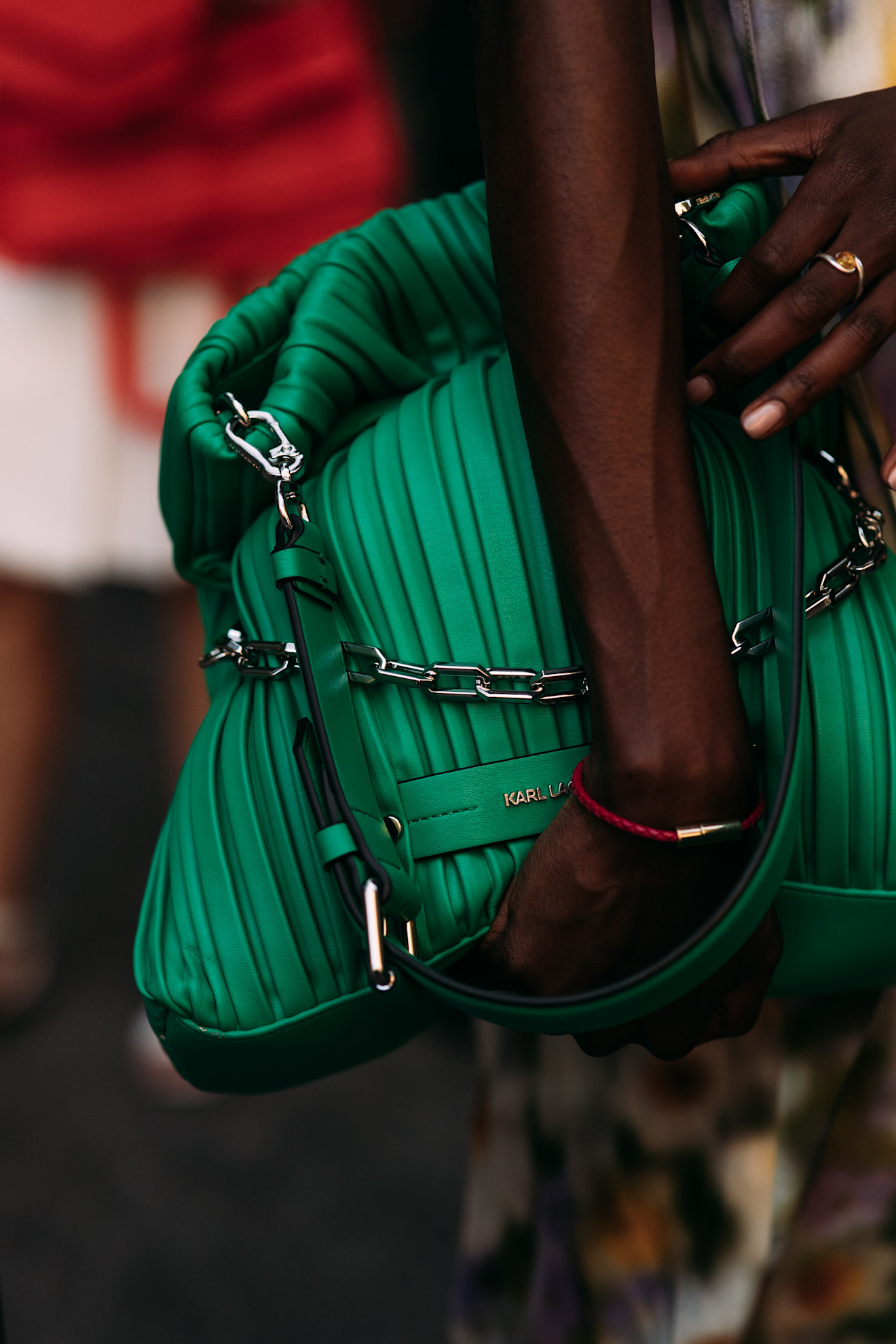 Milan Mens Fashion Week showgoer wears green in Milan.