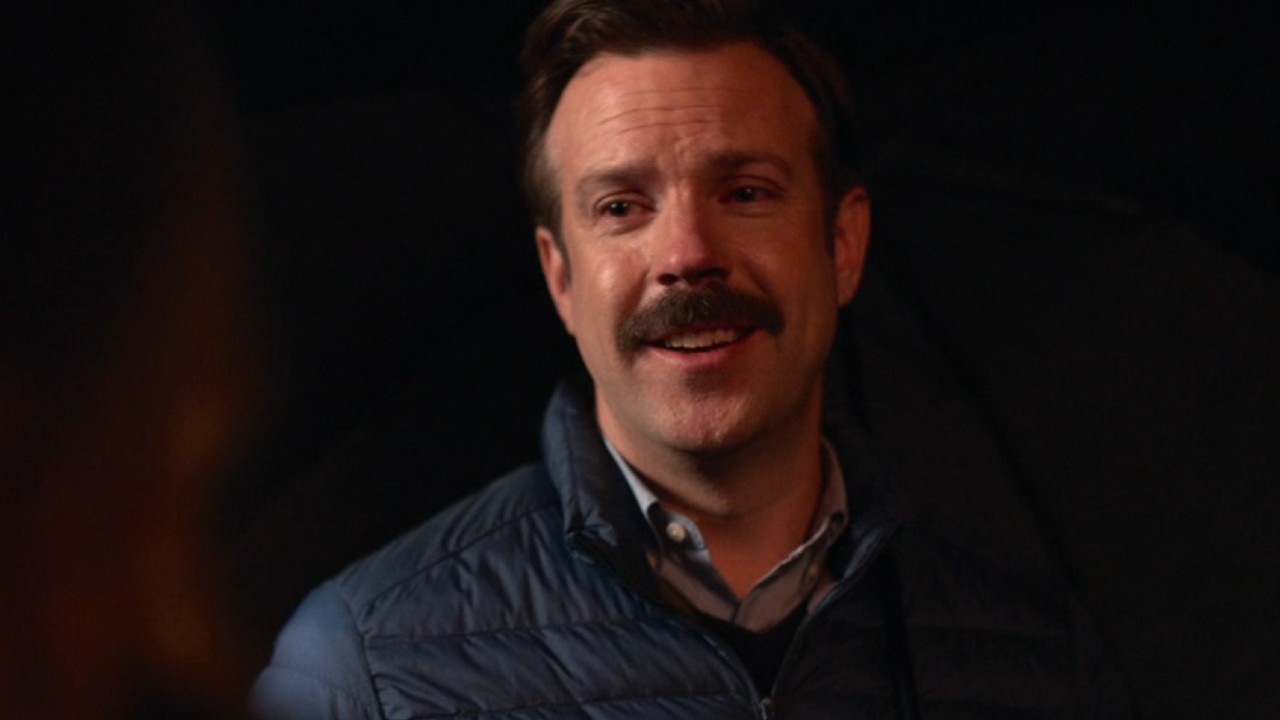Ted smiling while also crying.