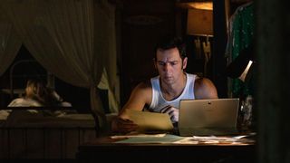DI Neville Parker (Ralf Little) at his computer in Death in Paradise season 12