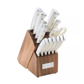 Wooden knife block with white utensils