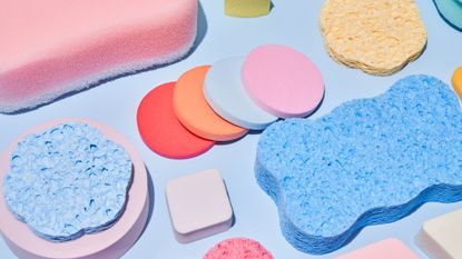 Cleaning supplies and sponges on a blue background